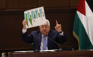 President Mahmoud Abbas holds up a chart during a leadership meeting at his headquarters, in the West Bank city of Ramallah on Sept. 3, 2020. (AP)