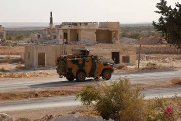 A Turkish military vehicle, part of a convoy, arrives to the Syrian opposition-controlled area, near al-Nayrab village, about 14Km southeast of Idlib city in northwestern Syria, on October 20, 2020, after vacating the Morek post in Hama's countryside. (AFP)