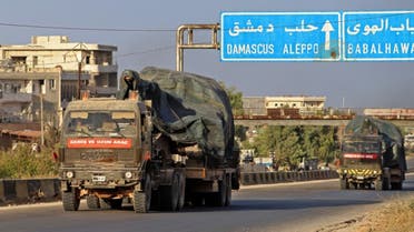 Turkish military vehicles, part of a convoy, drive through the town of Ariha in the rebel-held northwestern Idlib province on October 20, 2020, after vacating the Morek post in Hama's countryside. (AFP)