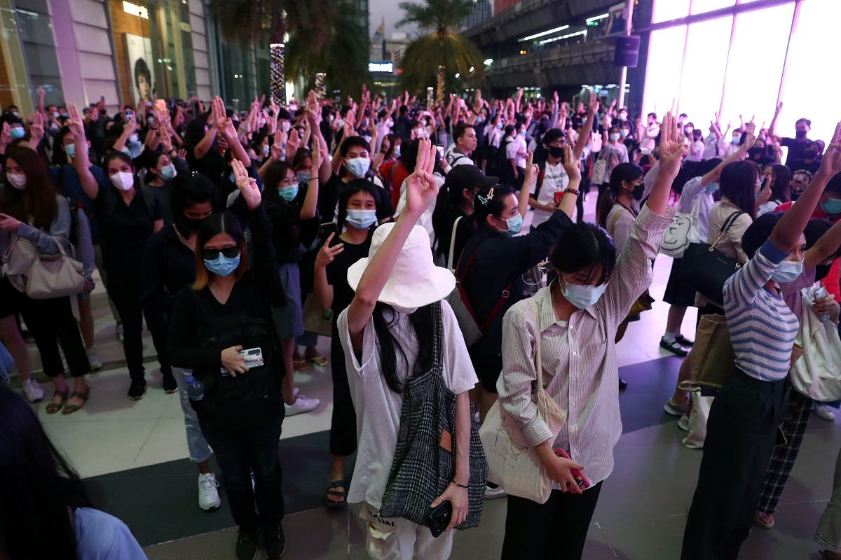 Pro-democracy protesters make a three-finger salute at 6:00 Pm, at the time the national anthem is usually played in all public transport stations in Bangkok, Thailand, on October 20, 2020. (Reuters)