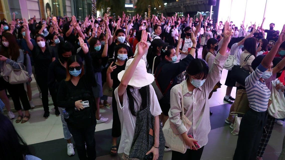 Pro-democracy protesters make a three-finger salute at 6:00 Pm, at the time the national anthem is usually played in all public transport stations in Bangkok, Thailand, on October 20, 2020. (Reuters)