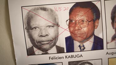 A file photo shows the date of arrest and a red cross are seen written on the face of Felicien Kabuga on a wanted poster at the Genocide Fugitive Tracking Unit office in Kigali, Rwanda, on May 19, 2020. (AFP/Simon Wohlfahrt)