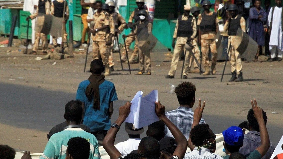 Sudanese protesters gather near riot police officers ahead of a rally to put pressure on the government to improve conditions and push ahead with reform in Khartoum, Sudan, on October 21, 2020. (Reuters)
