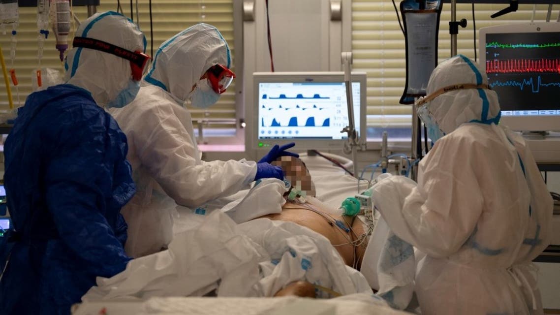 Healthcare workers attend to a coronavirus patient at the Intensive Care Unit (ICU) of the Severo Ochoa University Hospital in Leganes on October 16, 2020. (AFP)