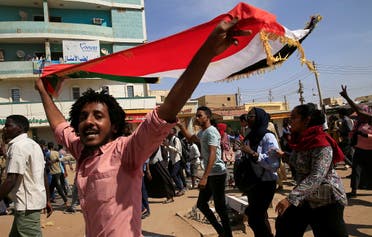 2020One of Sudanese protesters carries the national flag as they gather ahead of a rally to put pressure on the government to improve conditions and push ahead with reform in Khartoum, Sudan, on October 21, 2020. (Reuters)