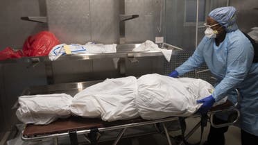 Transporter Morgan Dean-McMillan prepares the body of a COVID-19 victim at a morgue in Montgomery county, Maryland on April 17, 2020. (AFP)