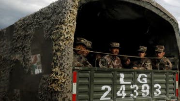 Chinese soldiers of the People’s Liberation Army (PLA) sit on the back of a truck on the highway to Nyingchi, Tibet Autonomous Region, China, on October 19, 2020. (Reuters)