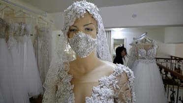 mannequin displays an embroidered protective mask with the matching wedding dress at a workshop in the Druze village of Majdal Shams in the Israel-annexed Golan Heights, on April 3, 2020, amid the coronavirus epidemic. (AFP)