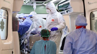 Medical staff transfer from the Garbagnate Milanaise hospital a patient with Covid-19 in a bio-containment stretcher for infectious diseases to Varese hospital near Milan on October 19, 2020. (AFP)