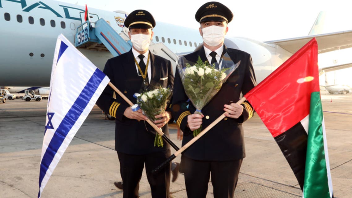 Etihad Airways crew on the ground in Tel Aviv in front of the airline's first passenger plane to Israel. (Twitter/Etihad)