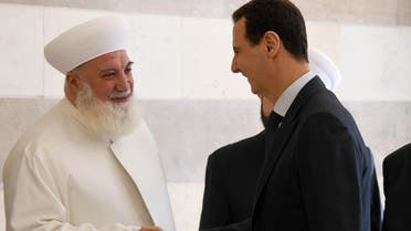 Syrian President Bashar al-Assad shaking hands with Mufti Adnan al-Afiouni during the inauguration of the center that is dedicated to counterterrorism and extremism, in Damascus. (File Photo: AFP)