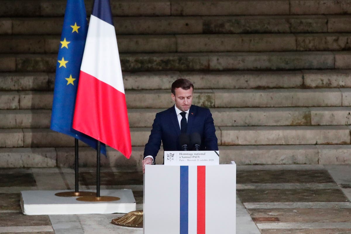 French President Emmanuel Macron delivers a speech in front of Samuel Paty’s coffin (unseen) inside Sorbonne University’s courtyard in Paris on October 21, 2020. (AFP)