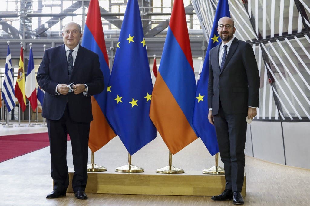 Armenian President Armen Sarkissian (L) poses with European Council President Charles Michel prior to a meeting in Brussels, on October 21, 2020. (AFP)