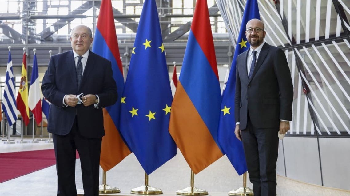 Armenian President Armen Sarkissian (L) poses with European Council President Charles Michel prior to a meeting in Brussels, on October 21, 2020. (AFP)