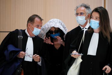 An alleged victim of Swiss academic Tariq Ramadan, hiding her face, gestures as she talks with her lawyers as she arrives to attend Tariq Ramadan's trial at the Paris courthouse, France, September 16, 2020. (Reuters)