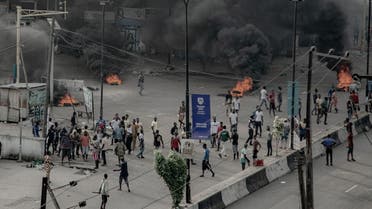 People are seen near burning tires on the street, in Lagos. (Reuters)