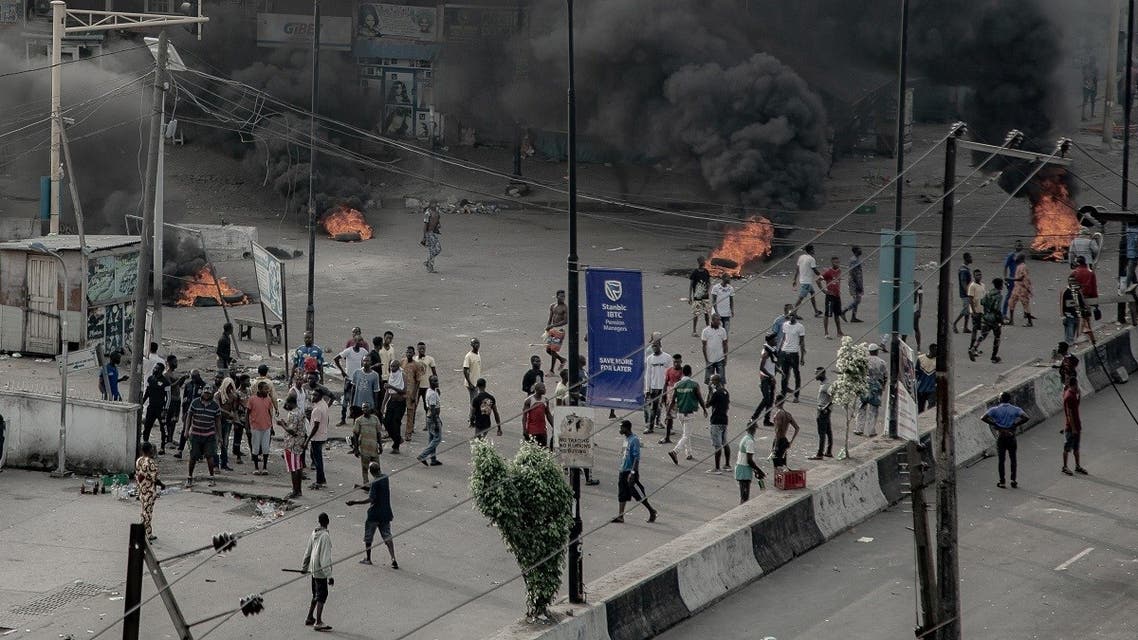 People are seen near burning tires on the street, in Lagos, Nigeria October 21, 2020, in this image obtained from social media. (Reuters)