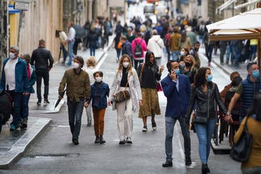 People wear face masks to prevent the spread of COVID-19 as they stroll in downtown Rome, Oct. 3, 2020. (AP)