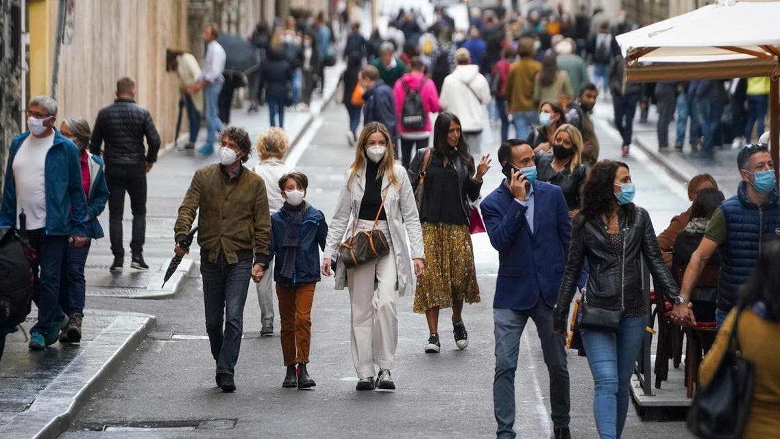 People wear face masks to prevent the spread of COVID-19 as they stroll in downtown Rome, Oct. 3, 2020. (AP)