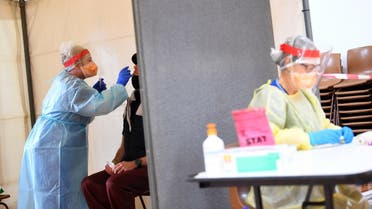 A healthcare worker tests a patient for the coronavirus disease at a testing facility in Kilmore outside of Melbourne, Australia, October 6, 2020. (Reuters)