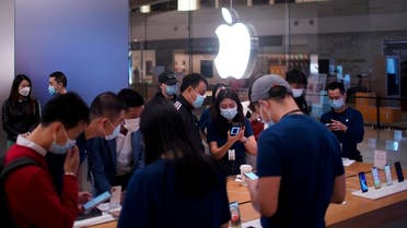 People look at Apple products at an Apple Store, as the coronavirus disease (COVID-19) outbreak continues in Shanghai China, on October 23, 2020. (Reuters)