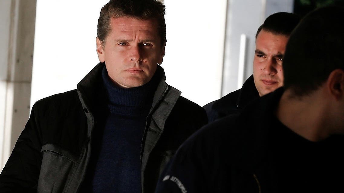 Alexander Vinnik, a 38 year old Russian man suspected of running a money laundering operation using bitcoin, is escorted by police officers to a court in Athens, Greece. (Reuters)