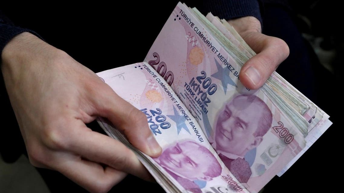 A merchant counts Turkish lira banknotes at the Grand Bazaar in Istanbul, Turkey. (Reuters)