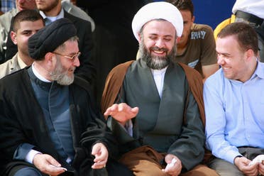 Hezbollah senior officials Ibrahim al-Amin (L), Nabil Qaouk (C) and Hassan Fadlallah laugh during celebrations after receiving the remains of Hezbollah and Palestinian fighters. July 16, 2008. (AP)