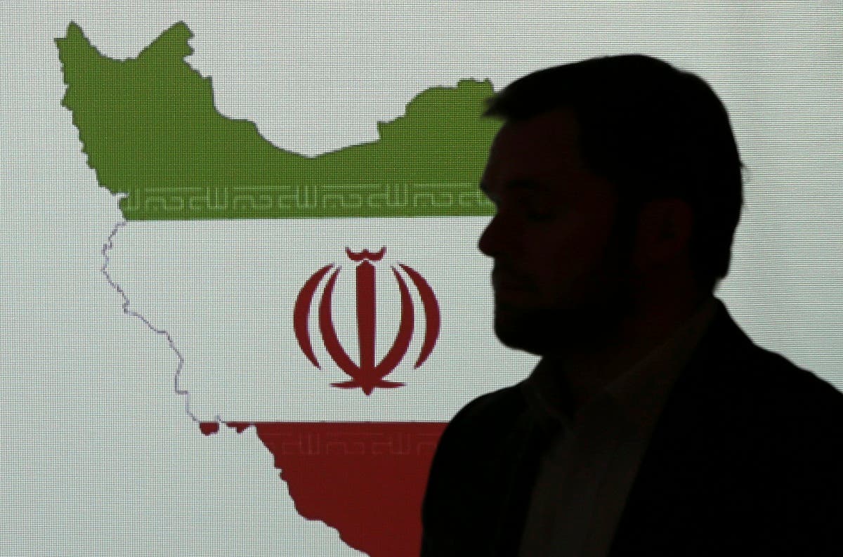 Stuart Davis, a director at one of FireEye's subsidiaries, stands in front of a map of Iran as he speaks to journalists about the techniques of Iranian hacking, Sept. 20, 2017, in Dubai. (AP)
