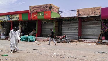 Sudanese men walk past closed shops in the capital Khartoum on June 11, 2019, on the third day of a civil disobedience campaign launched by protest leaders after a crackdown on a weeks-long sit-in left dozens dead on June 3. The protest strike kept most businesses shut and residents hunkered indoors in the Sudanese capital as a top US diplomat prepared a visit to press the ruling generals to halt a bloody crackdown. 