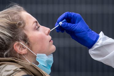 A woman gets a nasal swab at the coronavirus test center at Central Station in Cologne, Germany. (AP)