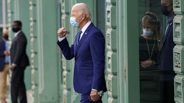 U.S. Democratic presidential candidate Joe Biden pumps his fist to supporters as he walks to his motorcade vehicle in downtown Wilmington, Delaware, U.S., October 23, 2020. REUTERS/Kevin Lamarque