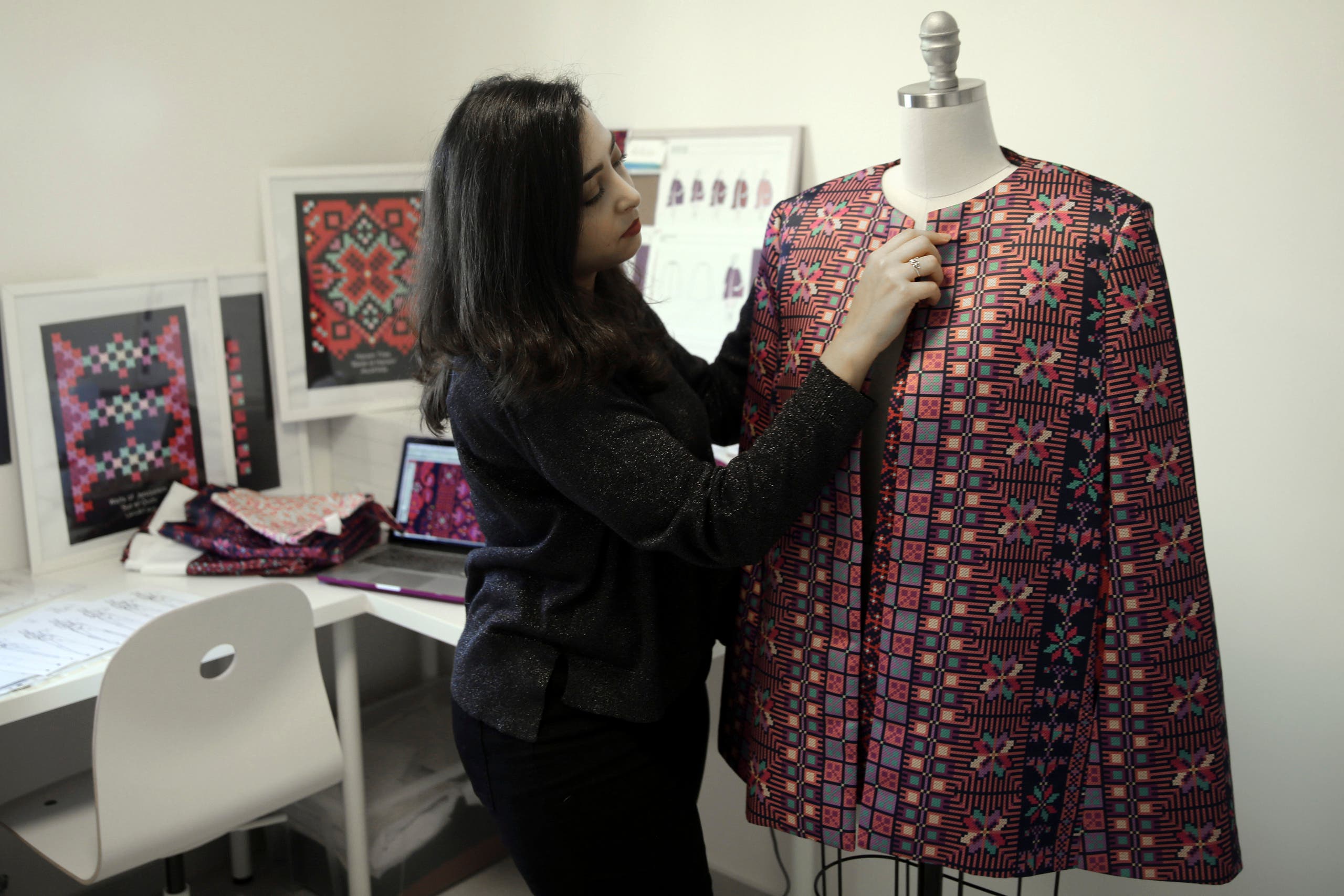 Designer Natalie Tahhan works on a modern version of the traditional Palestinian thobe in her studio in East Jerusalem on Jan. 29, 2019. (AP)