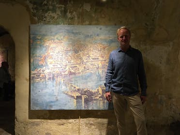 Beirut-based artist Tom Young pictured next to one of his paintings at an exhibition at the Hammam Al-Jadeed. (Robert McKelvey)