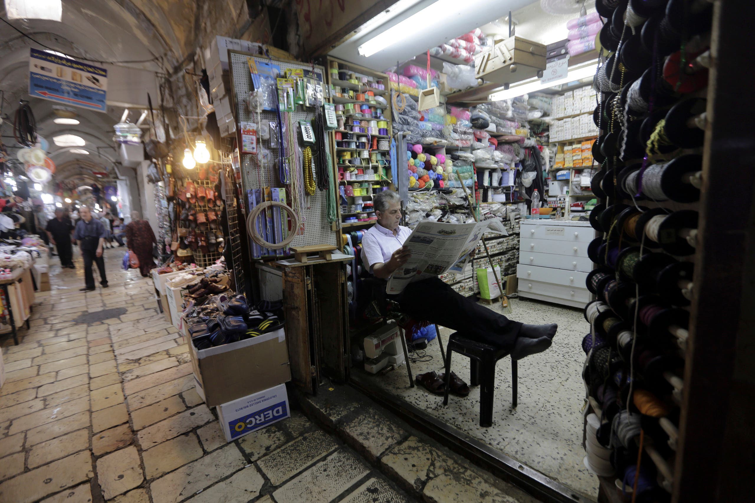 A shopkeeper waits for customers in the Muslim Quarter of the Old City in East Jerusalem on July 11, 2018. (AP)