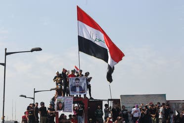 Iraqi protesters on Al-Jumhuriya Bridge in the capital Baghdad on October 25, 2020. (AFP)