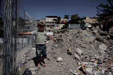 A Palestinian child walks near rubble in the East Jerusalem neighborhood of Silwan on June 21, 2010. (AP)