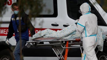 Medical specialists push a stretcher outside a hospital for patients infected with the coronavirus on the outskirts of Moscow, Russia October 23, 2020. (Reuters/Maxim Shemetov)