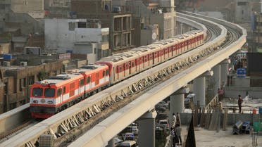 Orange Line Metro Train (OLMT) on its first test-run, travels along a track in a neighbourhood in Lahore, Pakistan. (Reuters)