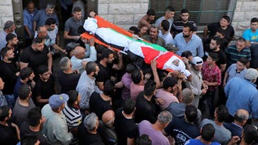 Palestinian mourners carry the body of 18-year-old Amer Abdel-Rahim Sanouber during his funeral in the village of Yatma in the occupied West Bank on Oct. 25, 2020. (AFP)