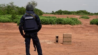 A Nigerien police officer stands guard in the Kouré Reserve, about 60 km from Niamey on August 21, 2020, at the scene where six French aid workers, their local guide and the driver were killed by unidentified gunmen riding motorcycles on August 9, 2020. (AFP)