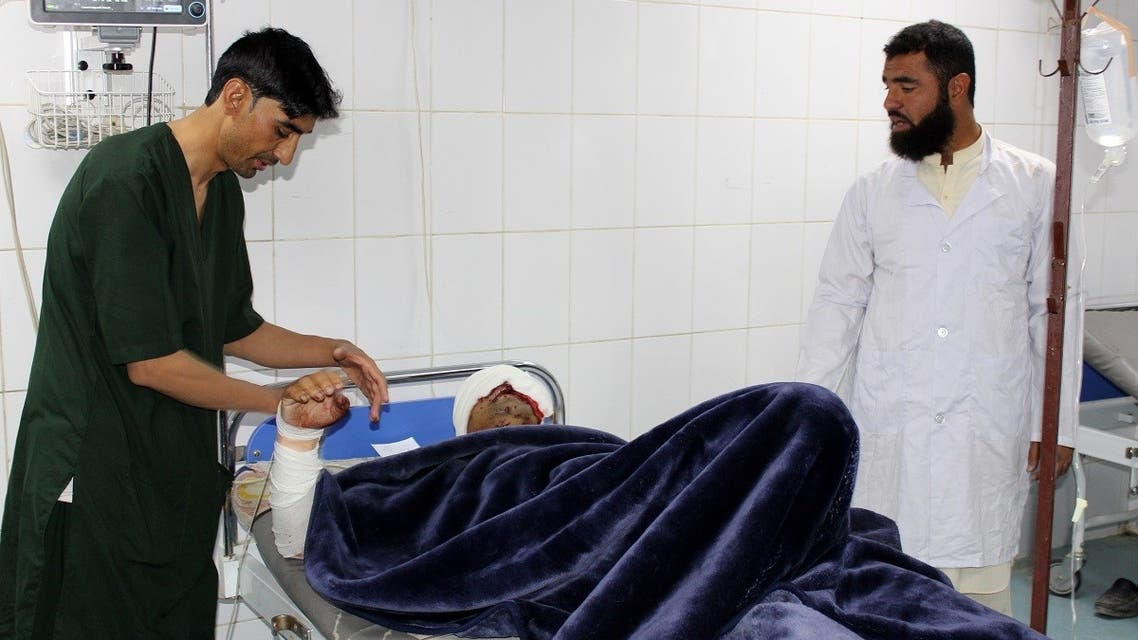 A wounded man receives medical treatment at a hospital after a car bomb attack on an Afghan police base in Khost province on October 27, 2020. (AFP/Farid Zahir)