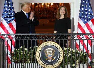 US President Donald Trump applauds Supreme Court Associate Justice Amy Coney Barrett after she took her oath of office and was sworn in to serve on the court in Washington. (Reuters)
