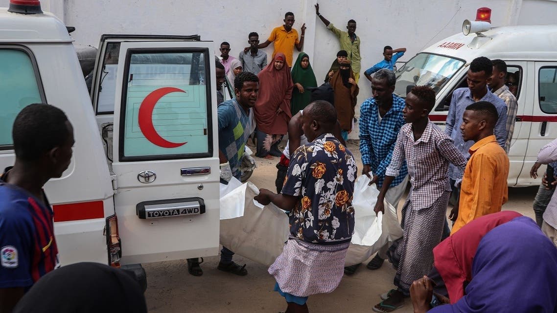 A file photo shows Somali men help to unload a victim, that was injured during a car bombing attack, at the Madina Hospital in Mogadishu, on December 28, 2019. (Abdirazak Hussein Farah/AFP)