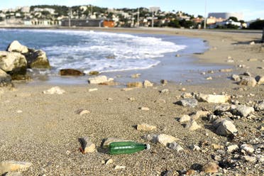 This picture taken in Marseille, southern France, shows a plastic bottle left on the beach by the Mediterranean sea on October 27, 2020. (AFP/Nicolas Tucat)