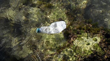 This picture taken in Marseille, southern France, shows a plastic bottle floating in the Mediterranean sea on October 27, 2020. (AFP/Nicolas Tucat)