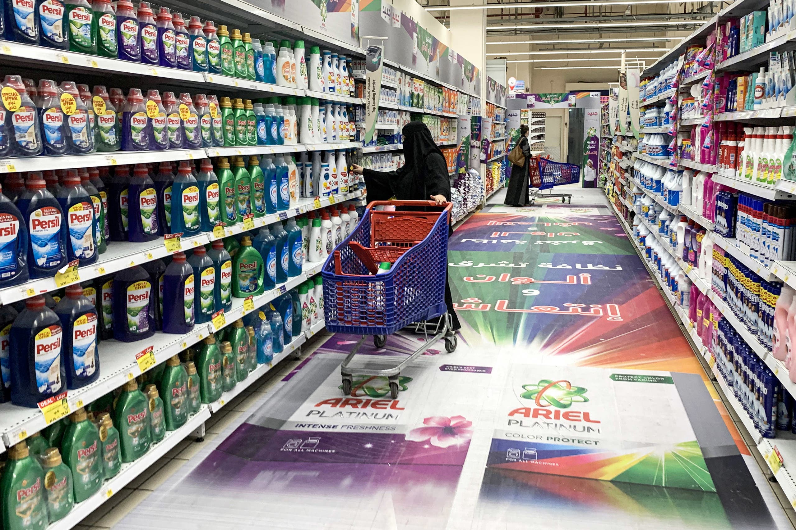 A woman shops for laundry detergent at a supermarket in Saudi Arabia's capital Riyadh on October 18, 2020. (AFP)