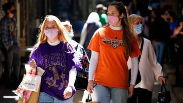 Shoppers walk down a city laneway after coronavirus restrictions were eased for the state of Victoria, in Melbourne, Australia, on October 28, 2020. (Reuters)