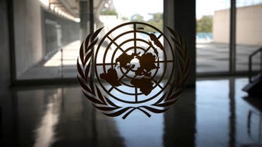 The UN logo is seen on a window in an empty hallway at UN headquarters in New York, Sept. 21, 2020. (Reuters)