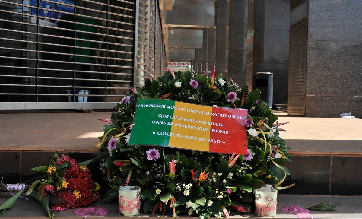 This file photo taken on November 24, 2015 shows the Malian flag reading the words Tribute to the victims of the Radisson Blu, may God welcome you in His infinite mercy laid on a floral wreath at the entrance the hotel in Bamako, after the deadly terrorist attack that left 27 people killed.(Habibou Kouyate/AFP)